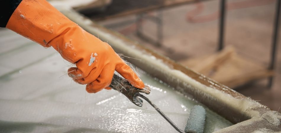 close up of gloved hands working with a roller
