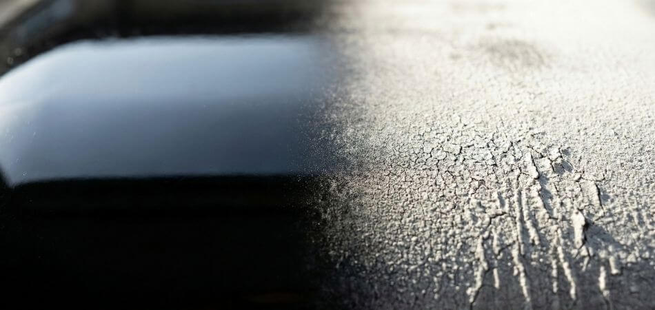 Close-up macro shot showing "chalking" and texture breakdown on a standard ABS plastic surface due to UV exposure.